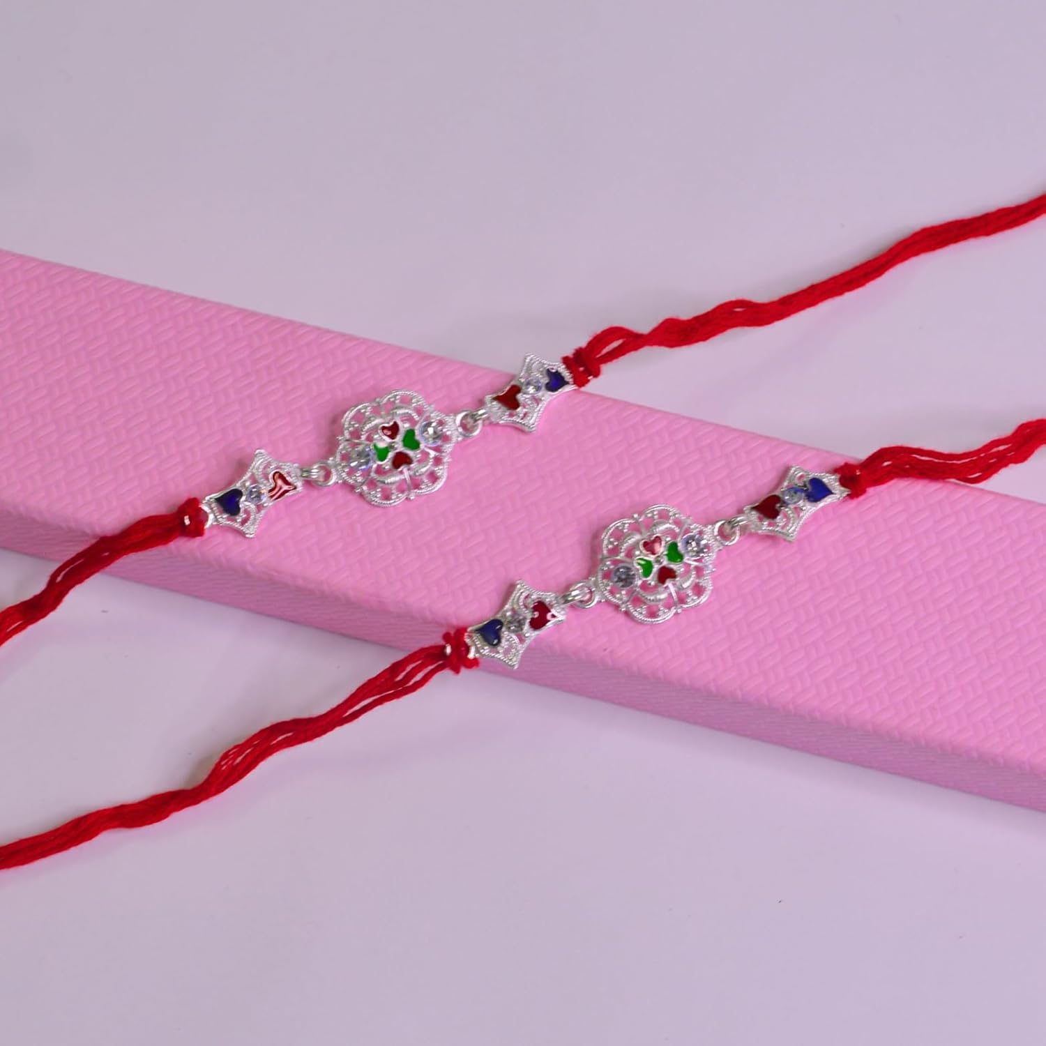 santarms Set of 2 Silver Flower Designer Rakhis with Red Threads, and Free Roli Chawal Pack - Rakhis for Brothers