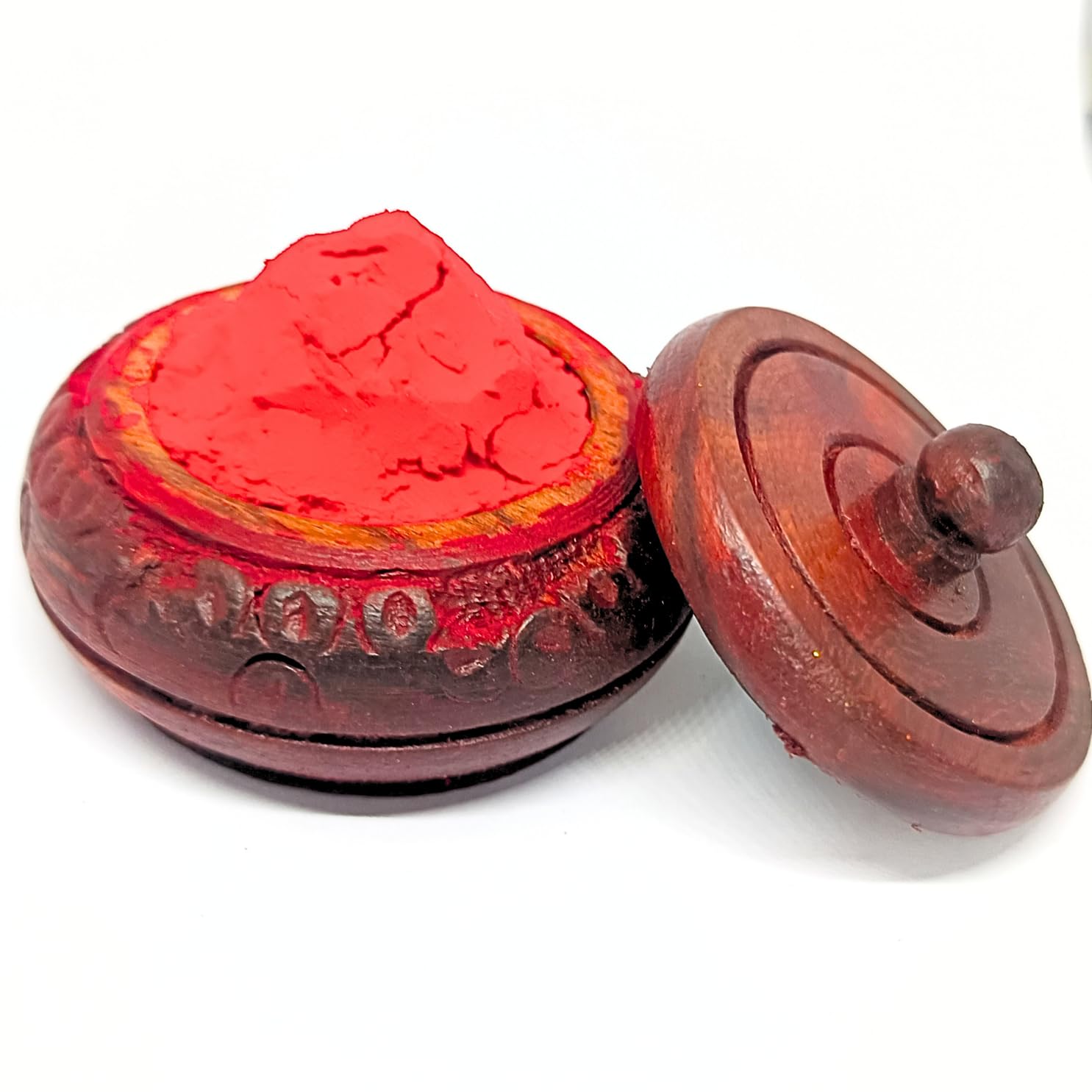 Married woman applying sindoor using wooden applicator stick Santarms