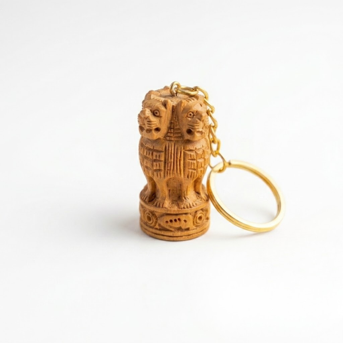 A small carved wooden keychain featuring a lion motif with gold-tone metal chain and key ring, shown on a plain white background.