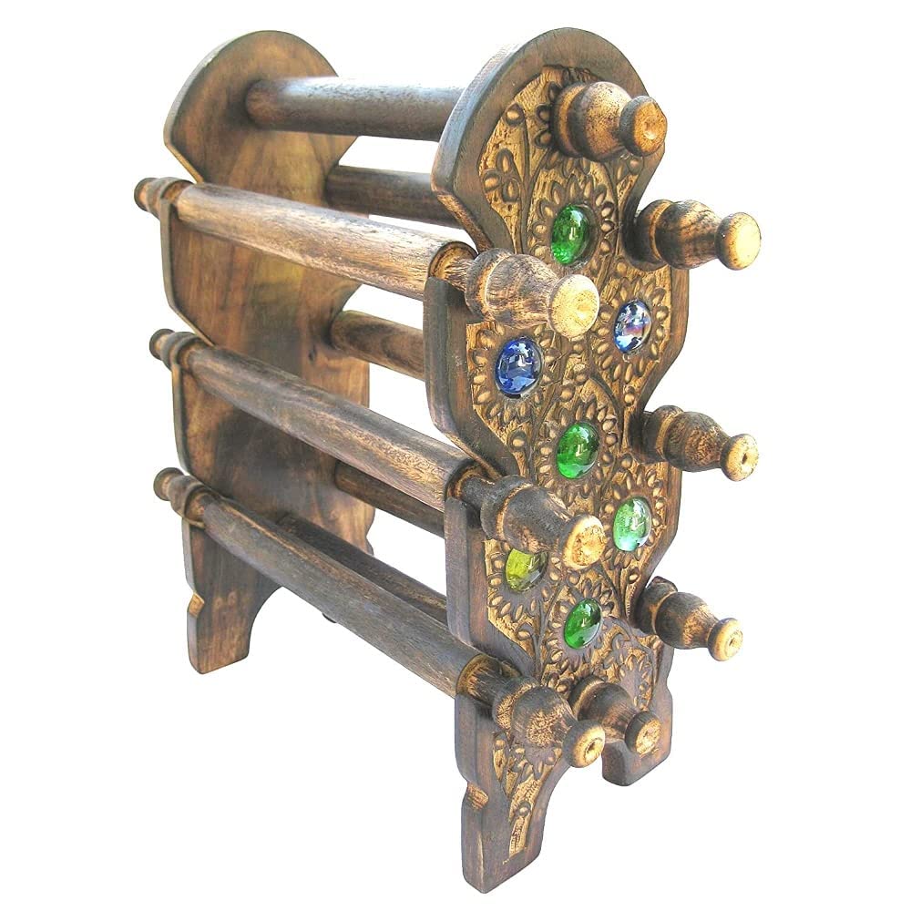A decorative wooden rack or stand with ornate carved details and colorful faux gemstone accents in blue, green, yellow, and white, shown on a plain white background.