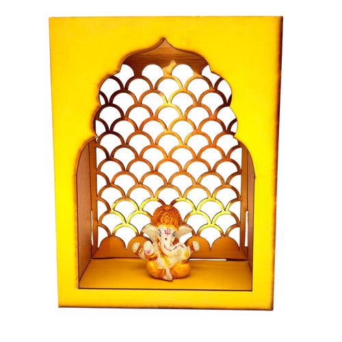 A decorative Ganesha wall niche display featuring a small Ganesha figurine seated inside a yellow arched wooden frame with a scalloped cutout pattern, shown against a plain white background.