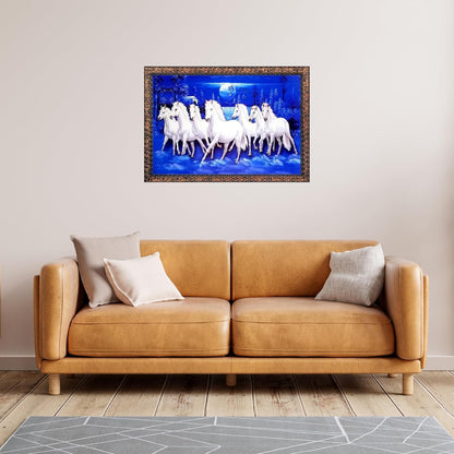A framed wall art print depicting a group of white horses against a vivid blue background, displayed above a tan leather sofa in a modern living room setting.