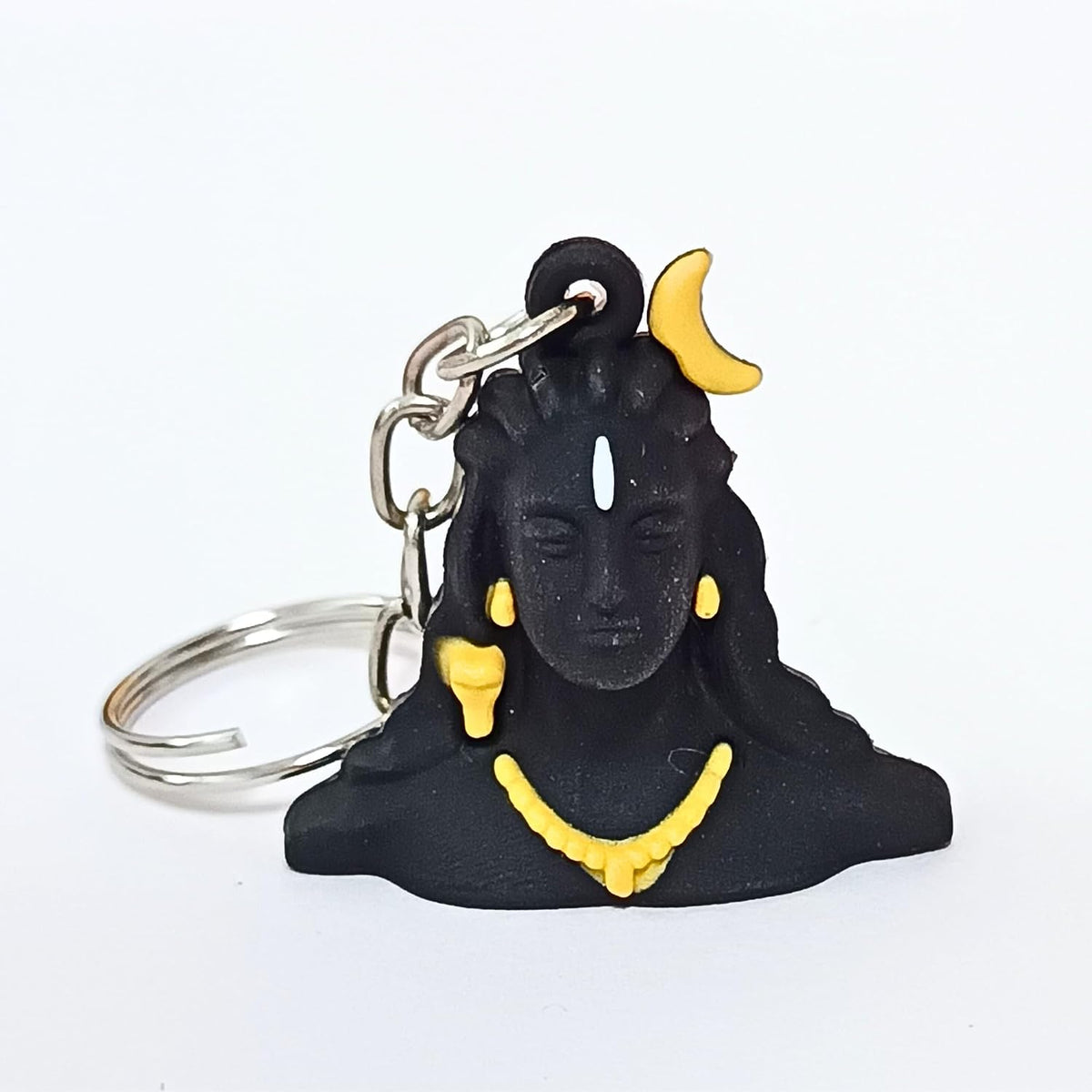 A black Shiva keychain charm with yellow accents, including a crescent moon, earrings, and necklace, attached to a silver metal split ring, shown on a plain white background.