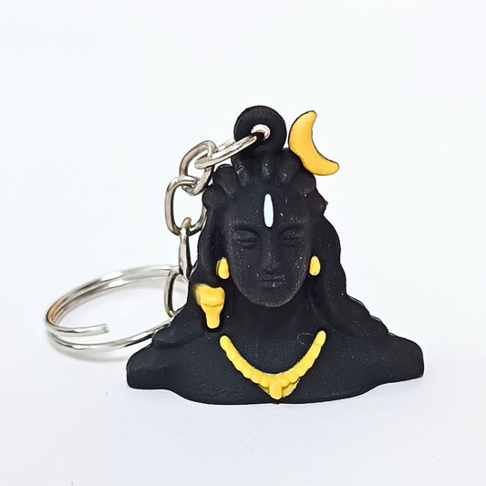 A black Shiva keychain charm with yellow accents, including a crescent moon, earrings, and necklace, attached to a silver metal split ring, shown on a plain white background.