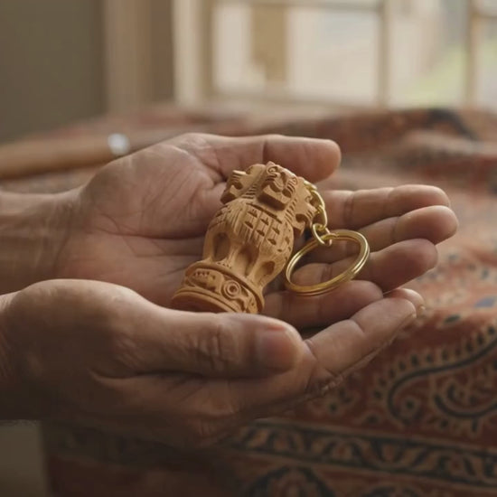 Buy handcrafted wooden Ashoka Pillar (Ashok Stambh) keychain. Finely carved 2-inch wood sculpture with durable gold key ring.