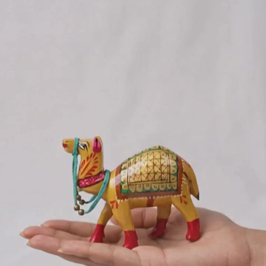 Santarms handcrafted wooden camel figurine with traditional gold Meenakari hand-painted details and a turquoise beaded harness.