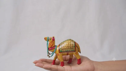 Santarms handcrafted wooden camel figurine with traditional gold Meenakari hand-painted details and a turquoise beaded harness.