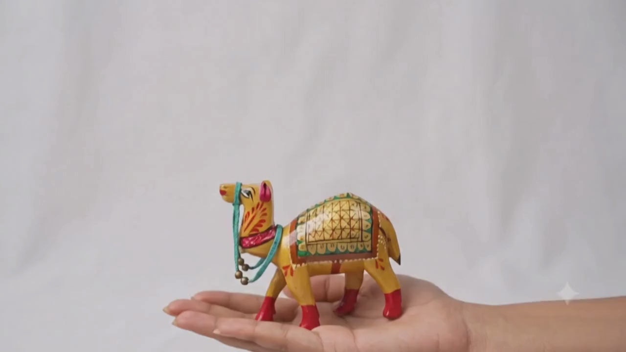 Santarms handcrafted wooden camel figurine with traditional gold Meenakari hand-painted details and a turquoise beaded harness.
