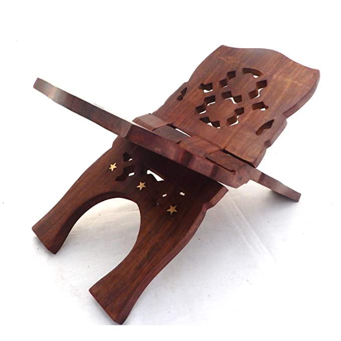A dark brown wooden book stand with intricate cutout patterns and small star-shaped cutouts, shown on a plain white background.
