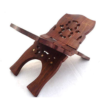 A dark brown wooden book stand with intricate cutout patterns and small star-shaped cutouts, shown on a plain white background.