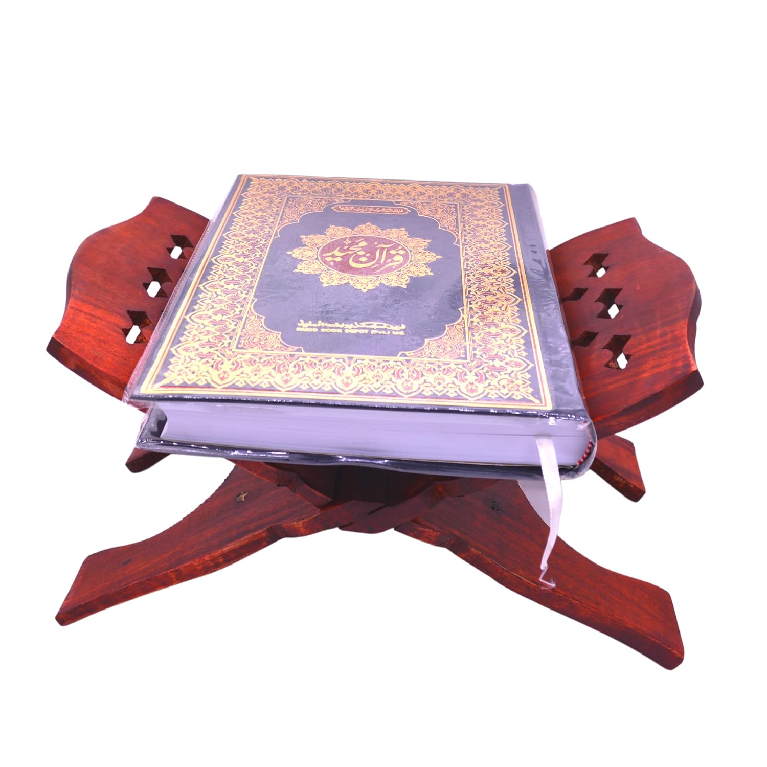 A hardcover Quran resting on a dark reddish-brown wooden prayer stand, isolated on a white background.