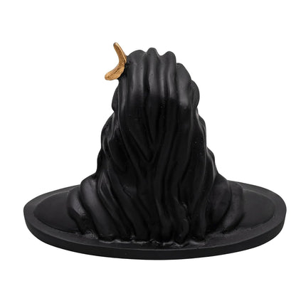 A black witch-style flame-shaped candle with a small gold crescent moon accent on top, set against a plain white background.