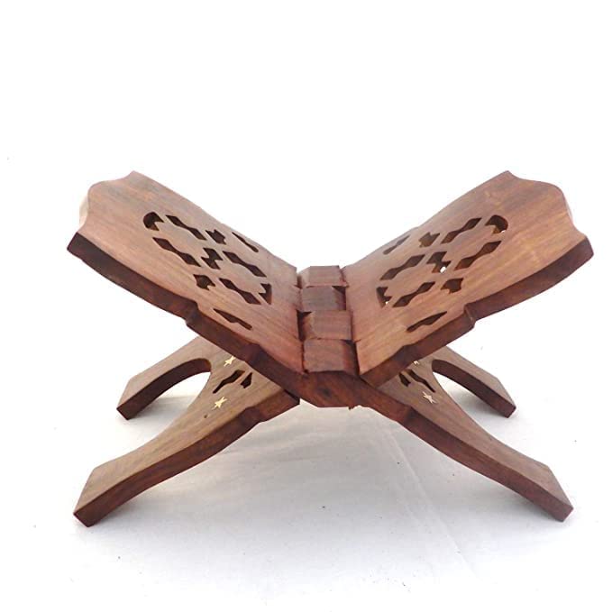 A wooden Islamic prayer stand with decorative cutout patterns on the curved top, shown on a plain white background.