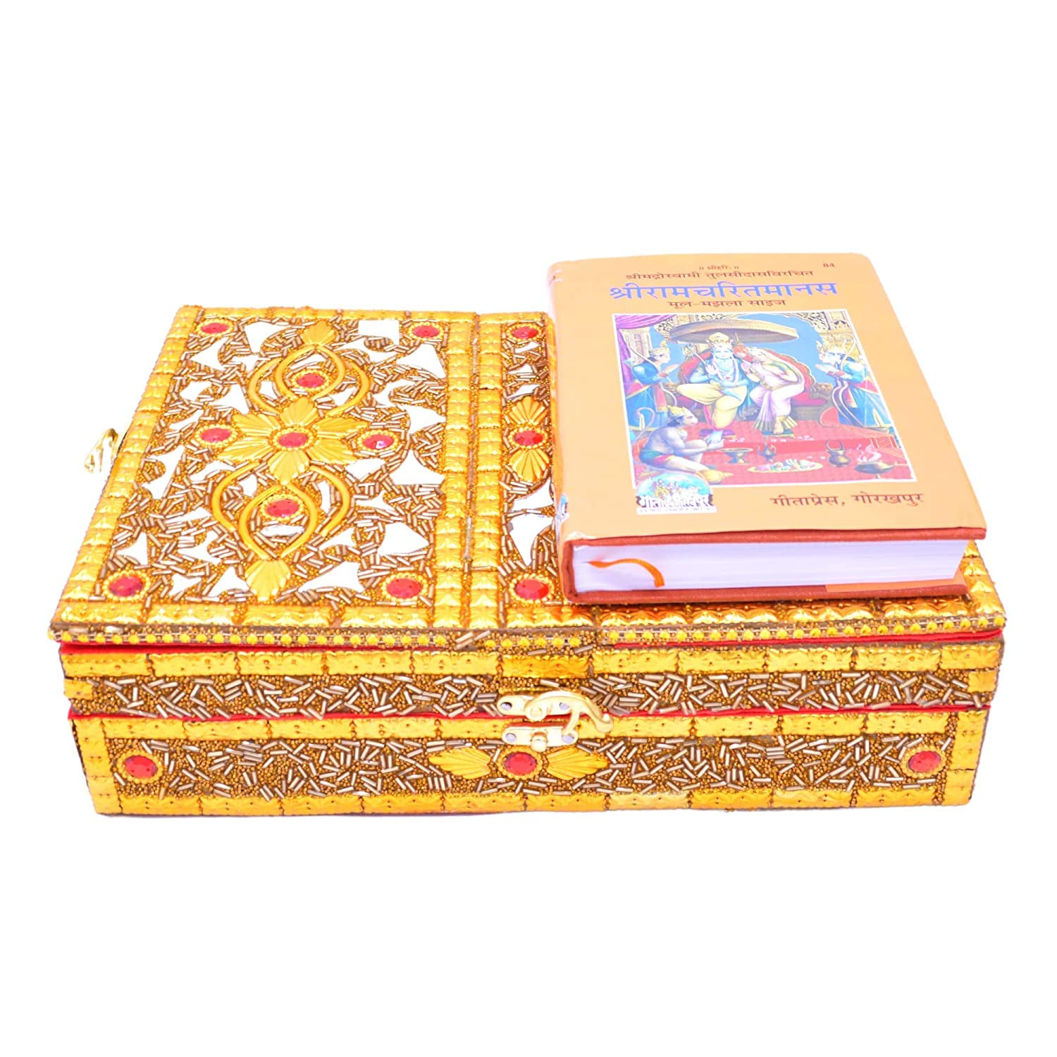 An ornate gold and white embroidered decorative box with red accents, featuring a small latch on the front. A copy of the Shrimad Bhagavad Gita rests on top of the box, which is photographed against a solid white background.